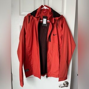 Womens nike rain jacket size LARGE new with tags. Burnt orange color